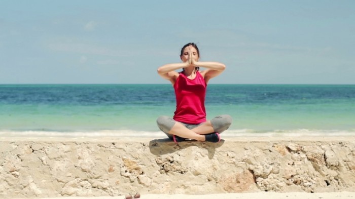 stock footage young beautiful woman meditating by the sea 700x393 Медитация   Meditation