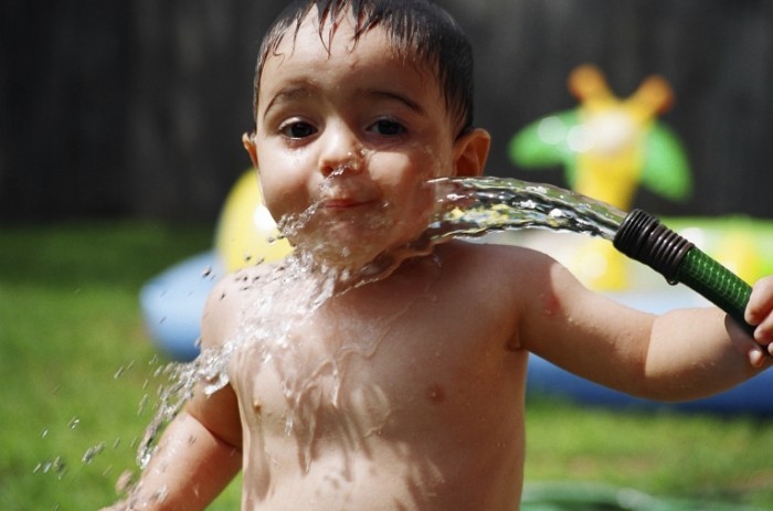 Kid garden hose summer may 2011 istock 700x463 Ребенок со шлангом воды   Child with a water hose