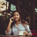 Девушка разговаривает по телефону в кафе - The girl is talking on the phone in a cafe