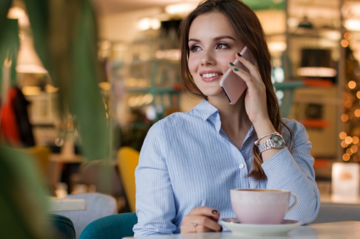 Devushka s telefonom za stolikom v kafe ulyibaetsya Girl with a phone at a table in a cafe smiling 4776  3184 700x466 Девушка с телефоном за столиком в кафе улыбается   Girl with a phone at a table in a cafe smiling 